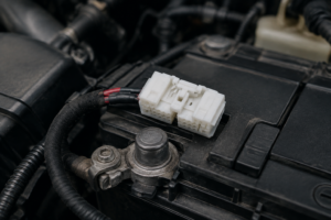 Battery post terminal installed on a vehicle battery in a fleet service bay
