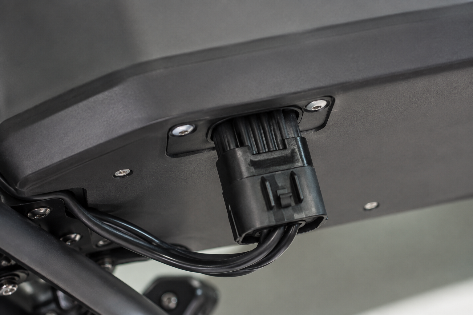 Electric bike battery connector routing in a fleet workshop