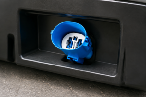 CNSJ blue connector positioned in an e-bike battery docking enclosure